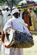 Drumming priest at procession during Timkat. Lalibela. Ethiopia.