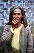 Local woman (from hill tribe) is smoking traditional burma cigar called cheroot. Area around Kalaw village. Myanmar (Burma).