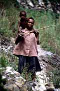 Villager from Dani tribe carrying small child. Papua,  Indonesia.