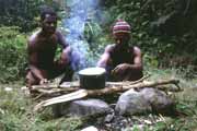 Guides are cooking lunch during trekking. Papua,  Indonesia.