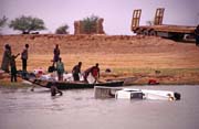 Car at Niger river. It fall from ferry. Mali.