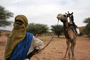 Nomad man together with his camel. Camel is the most frequent transportation option here. Sahara desert. Niger.