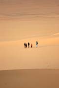 Arrakau - nomad family comes through sand dunes. Sahara desert. Niger.