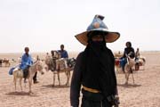 Family of nomad tuareg goes to new grassland. Sahara desert. Niger.