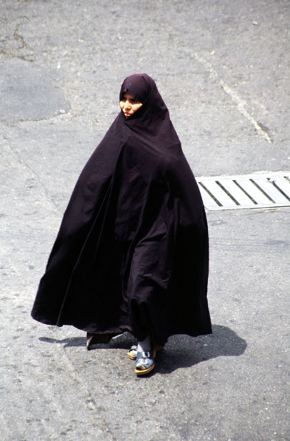 Iran woman. She is dressed in traditional black chador. Tehran. Iran.