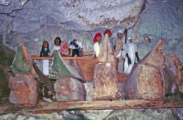 Old graves at cave. Tau tau figures and ship=shaped cofins. Tana Toraja area. Sulawesi,  Indonesia.