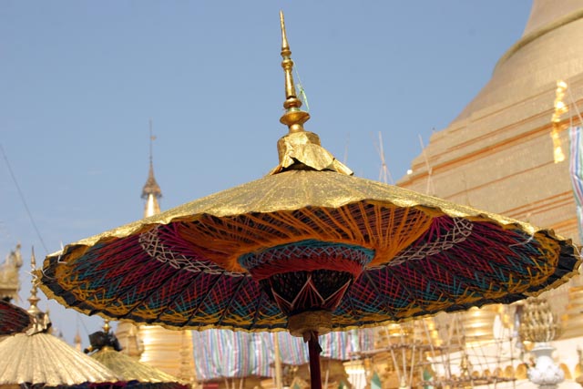 Umbrella is used for decoration and sun protection too. Novitiation ceremony at Shwedagon Paya, Yangon. Myanmar (Burma).