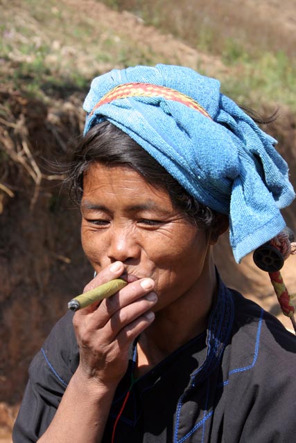 Woman from Pa-O hill tribe is smoking cheroot - traditional Burmese cigar. Villages around Inle Lake. Myanmar (Burma).