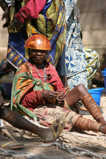 Woman at Tourou village at Mandara Mountains. Local fashion is red wooden calabashes on women' heads. They look rather like army helmets and which indicate things like their marital status. Cameroon.