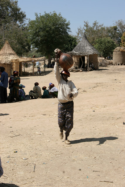Next ballon full of local alcohol is transported to the market. Market at Tourou village at Mandara Mountains. Cameroon.