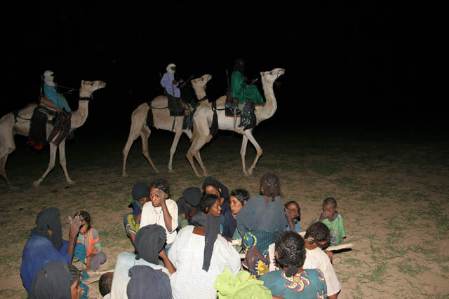 Tuareg women singing and tuareg men camel dancing. Campement of nomad Tuareg. Sahara desert. Niger.