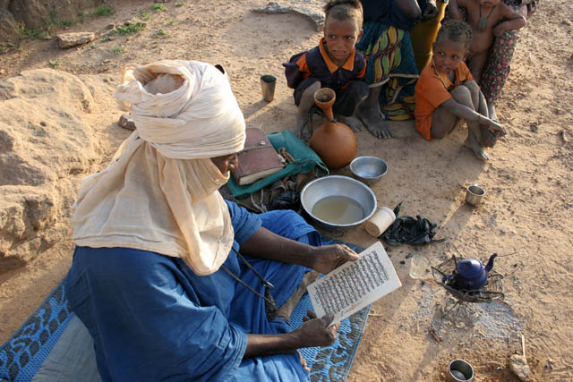 Holy Koran reading. Morning at campement of nomad Tuareg. Sahara desert. Niger.