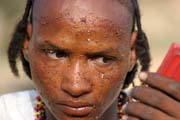 Man from nomadic Wodaab tribe (also called Bororo) prepares himself for Yaake dance. Gerewol festival. Niger.